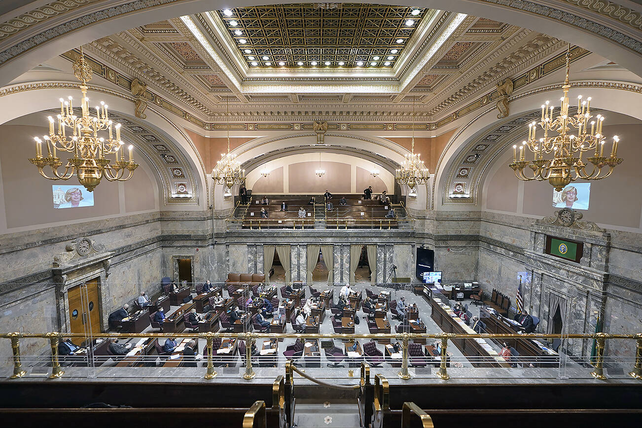 Lawmakers meet on the Senate floor, Thursday, March 10, 2022, at the Capitol in Olympia, Wash. Washington lawmakers were wrapping up their work Thursday with final votes on a supplemental state budget and a transportation revenue package before planning to adjourn the legislative session. (AP Photo/Ted S. Warren)