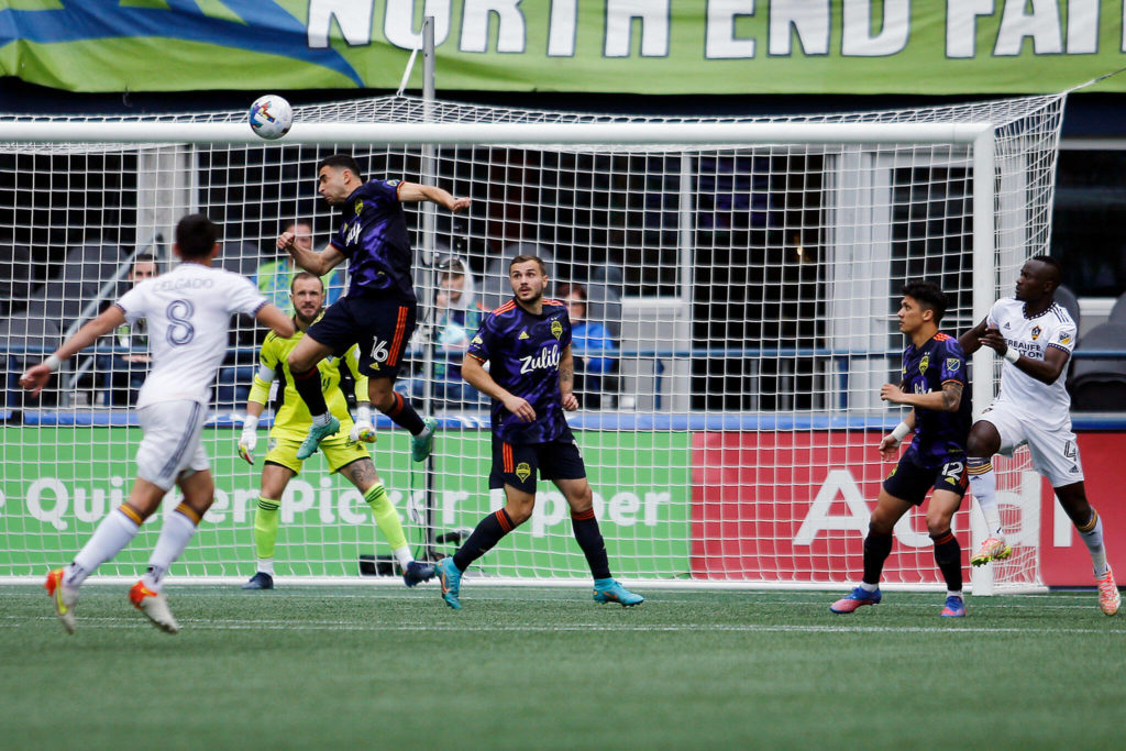 The Seattle Sounders’ Alex Roldán heads away a ball in the box against the Los Angeles Galaxy Saturday, March 12, 2022, at Lumen Field in Seattle, Washington. (Ryan Berry / The Herald)
