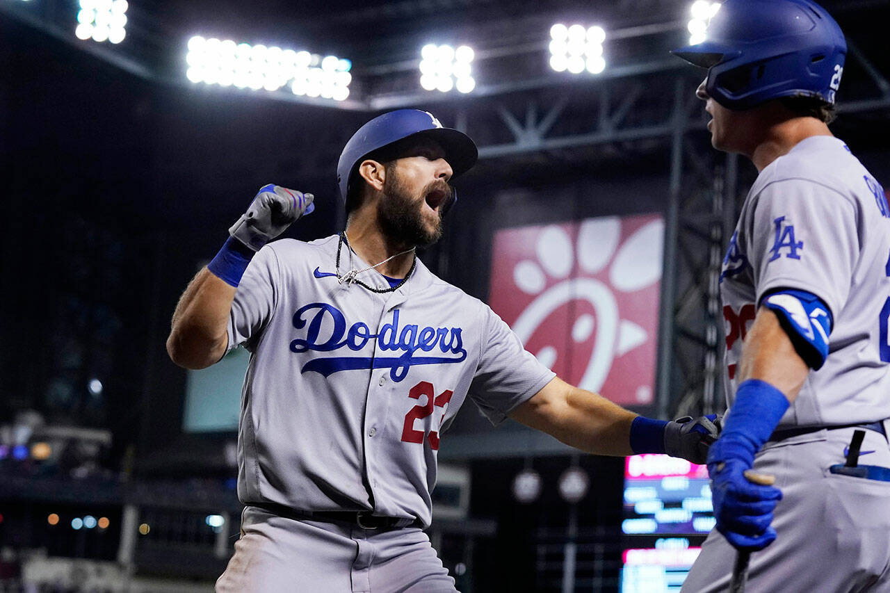 Steven Souza (left) celebrates his home run while playing for the Los Angeles Dodgers against the Arizona Diamondbacks during a game June 18, 2021, in Phoenix. (AP Photo/Ross D. Franklin)