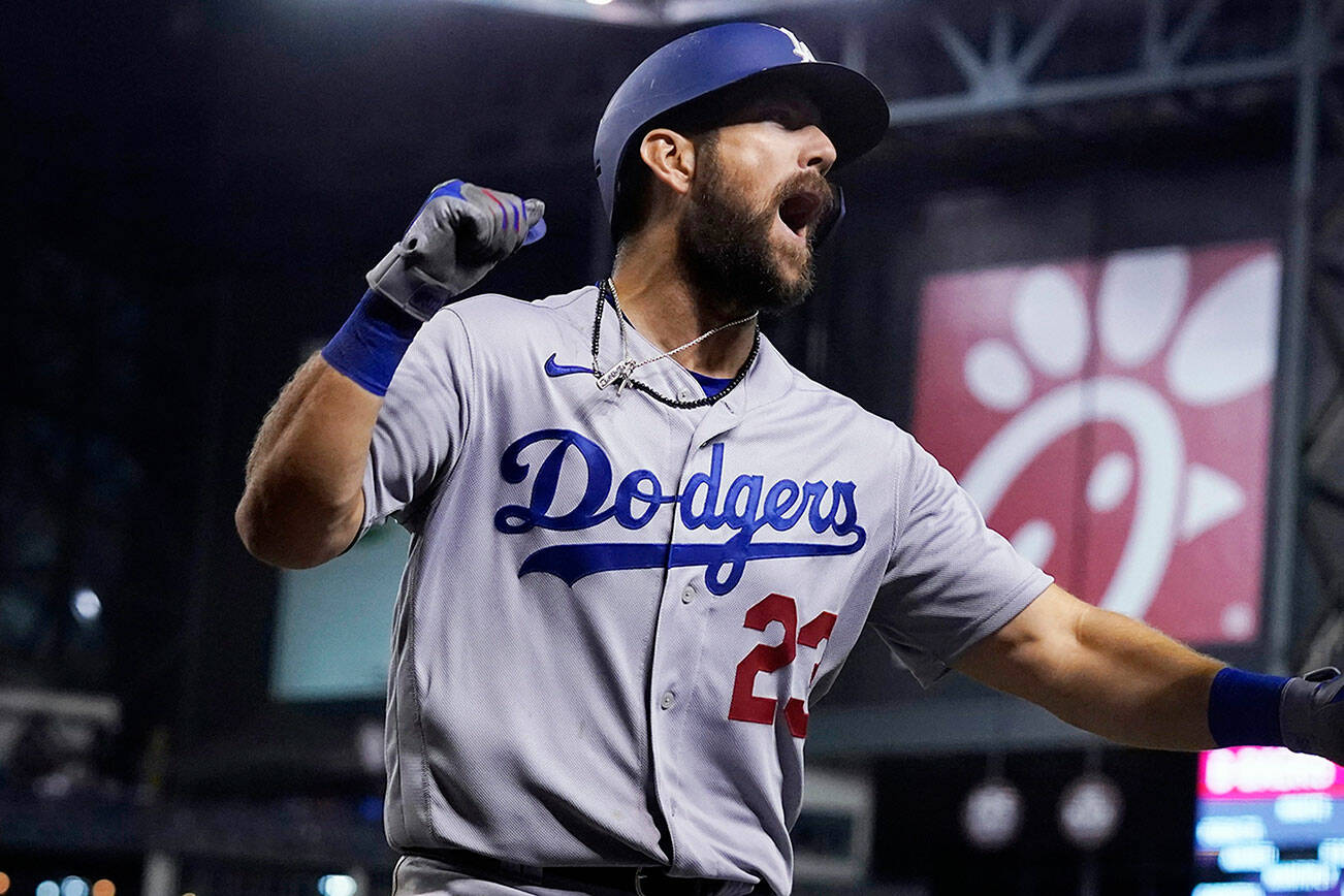 Los Angeles Dodgers' Steven Souza, left, celebrates his home run against the Arizona Diamondbacks with Andy Burns during the eighth inning of a baseball game Friday, June 18, 2021, in Phoenix. (AP Photo/Ross D. Franklin)