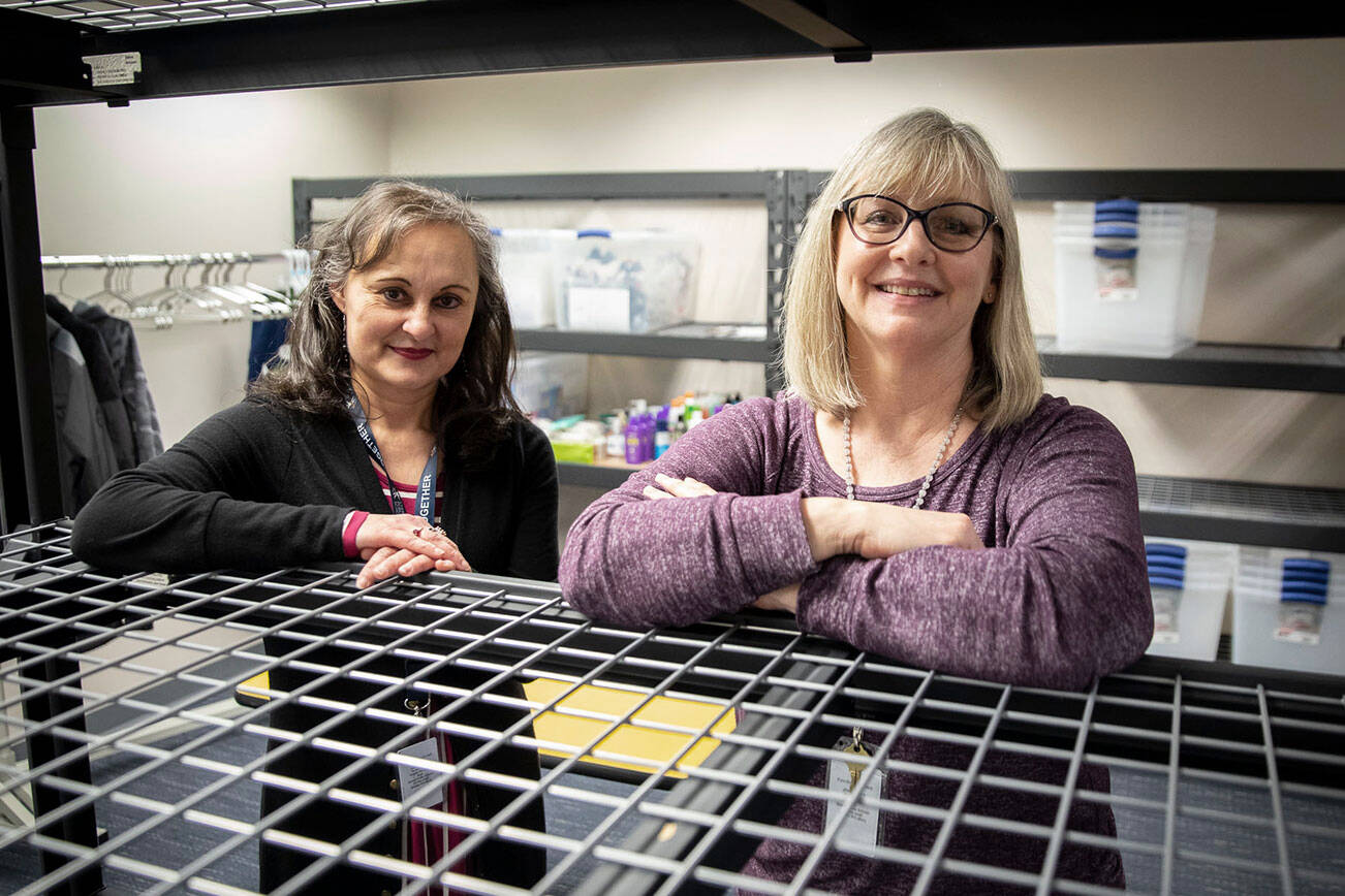 Family Resource Center support assistant Conchita Chinchilla, left, and resource coordinator Lyn Lauzon, right, at the new Family Resource Center in Hawthorne Elementary on Friday, March 18, 2022 in Everett, Washington. (Olivia Vanni / The Herald)