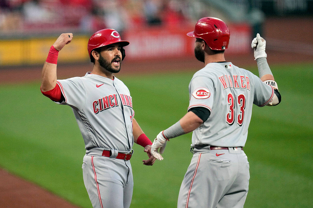 Jesse Winker (33) is congratulated by Eugenio Suarez after hitting a two-run home run for the Cincinnati Reds during a game June 3, 2021, in St. Louis. The Seattle Mariners acquired Winker and Suarez in a trade Monday. (AP Photo/Jeff Roberson)