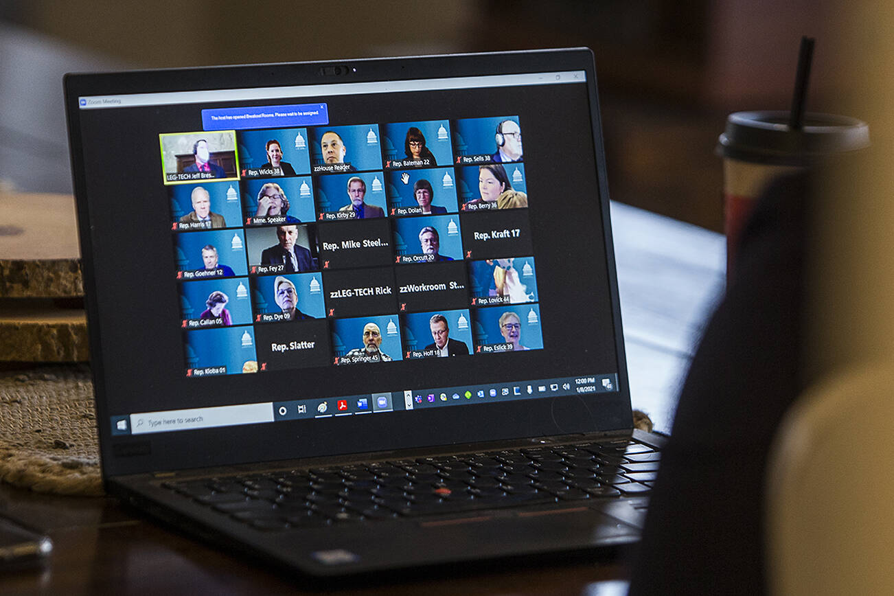 Other state representatives respond to roll call over a virtual meeting before their swearing in on Friday, Jan. 8, 2020 in Everett, Wa. (Olivia Vanni / The Herald)