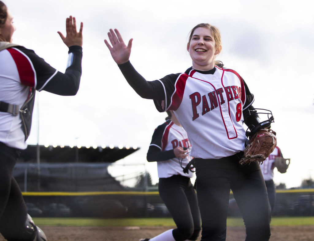 Snohomish’s Bridget Johnson high fives her teammate after a strike out during the game against Glacier Peak on Wednesday in Snohomish. (Olivia Vanni / The Herald)
