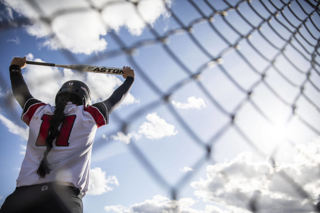 Snohomish’s Eva Massena stretches before going up to bat during the game against Glacier Peak on Wednesday in Snohomish. (Olivia Vanni / The Herald)

