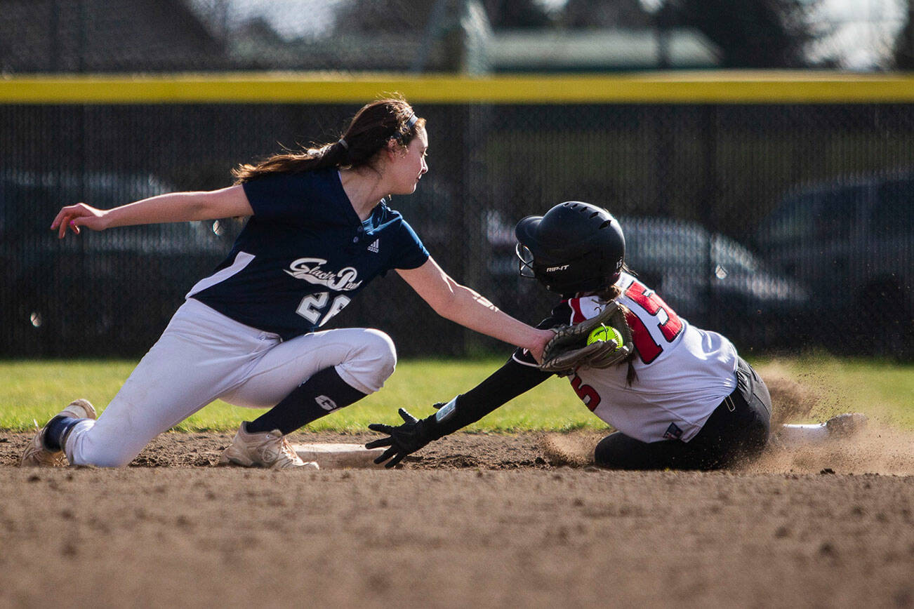 Glacier Peak’s Lauren Hufford tags out Snohomish’s Camryn Sage as she slides into second base during the game on Wednesday, March 16, 2022 in Snohomish, Washington. (Olivia Vanni / The Herald)