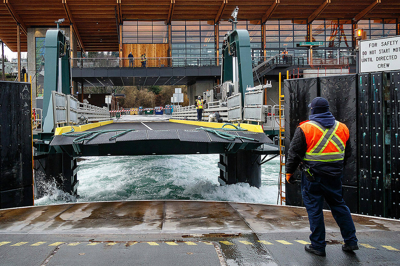 A ferry worker gazes back at the Mukilteo ferry terminal as the vessel departs the dock. (Photo by David Welton)