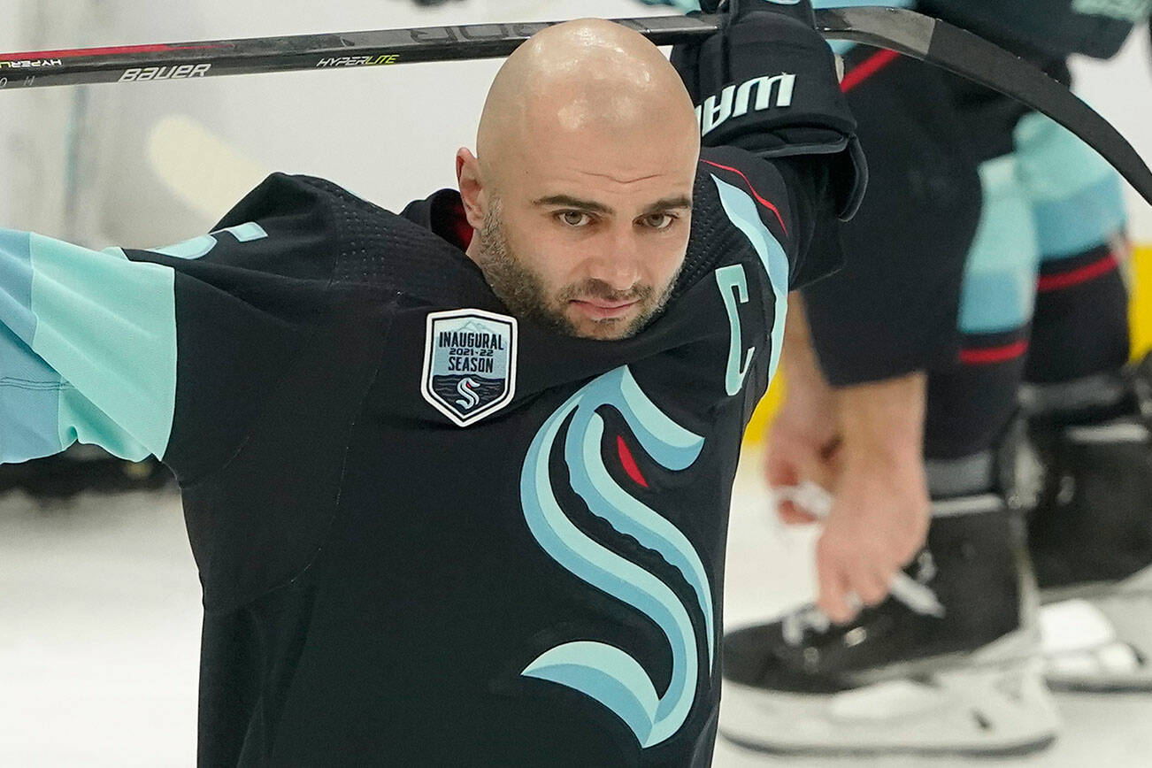 Seattle Kraken defenseman Mark Giordano holds his stick during warmups before an NHL hockey game against the Tampa Bay Lightning, Wednesday, March 16, 2022, in Seattle. Giordano was honored before the game for his 1000th career NHL game, which took place March 5, 2022 on the road against the Washington Capitals. (AP Photo/Ted S. Warren)