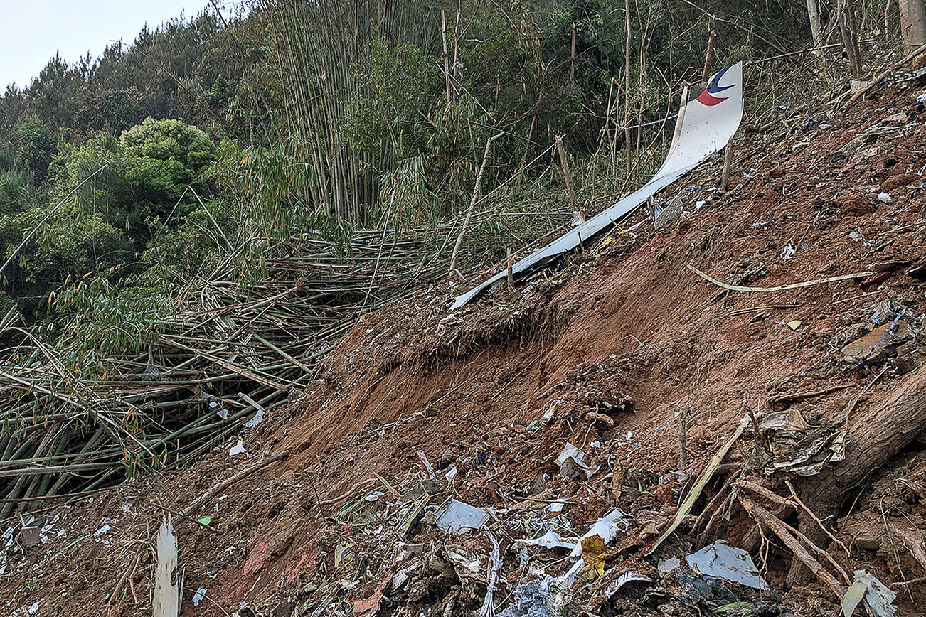 In this photo taken by mobile phone released by Xinhua News Agency, a piece of wreckage of the China Eastern's flight MU5735 are seen after it crashed on the mountain in Tengxian County, south China's Guangxi Zhuang Autonomous Region on Monday, March 21, 2022. A China Eastern Boeing 737-800 with 132 people on board crashed in a remote mountainous area of southern China on Monday, officials said, setting off a forest fire visible from space in the country's worst air disaster in nearly a decade. (Xinhua via AP)