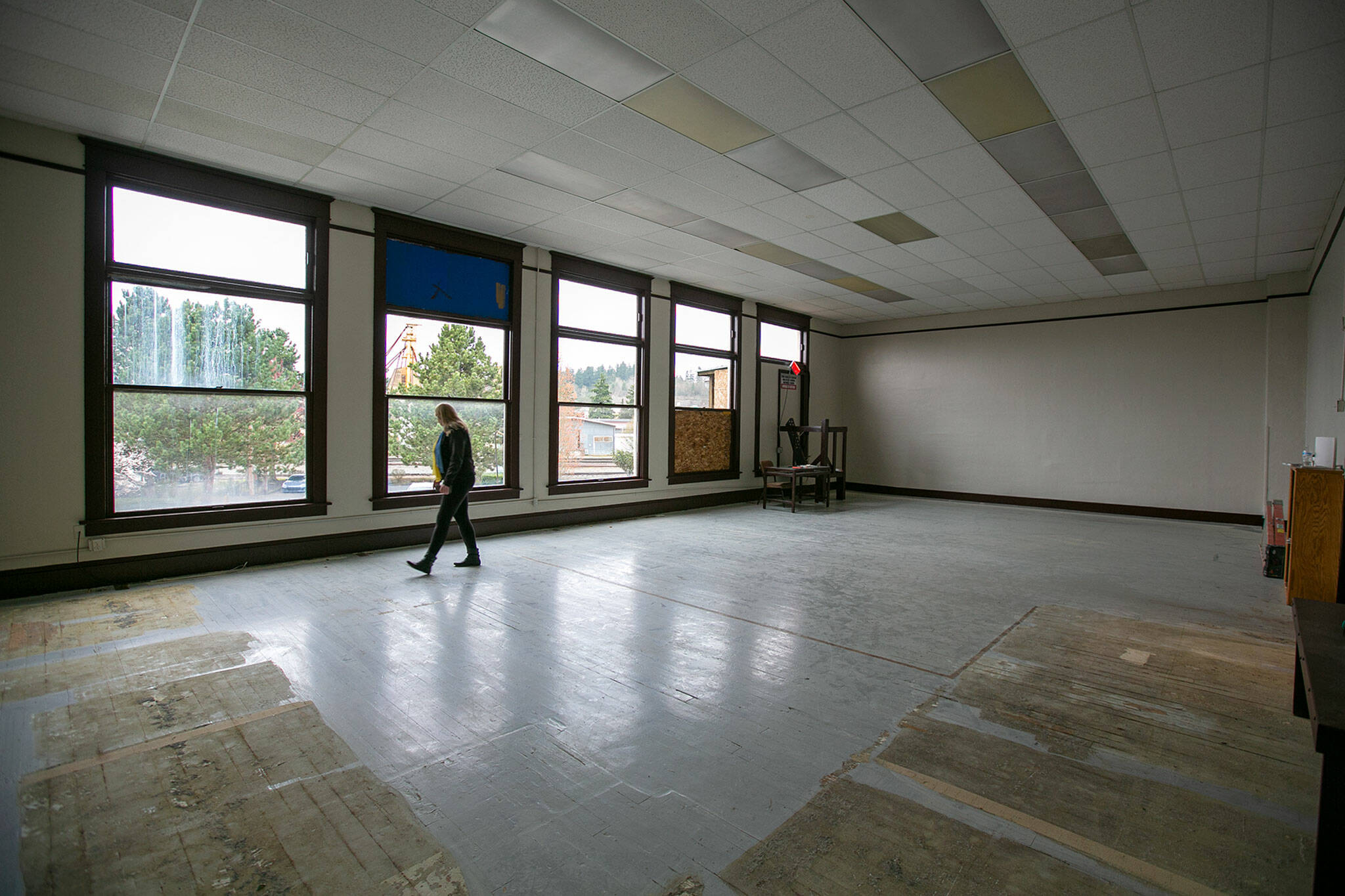 Monroe Historical Society board member Valeria Rae walks around the upstairs space, formerly the library, at the historical society’s downtown building Wednesday in Monroe. (Ryan Berry / The Herald)