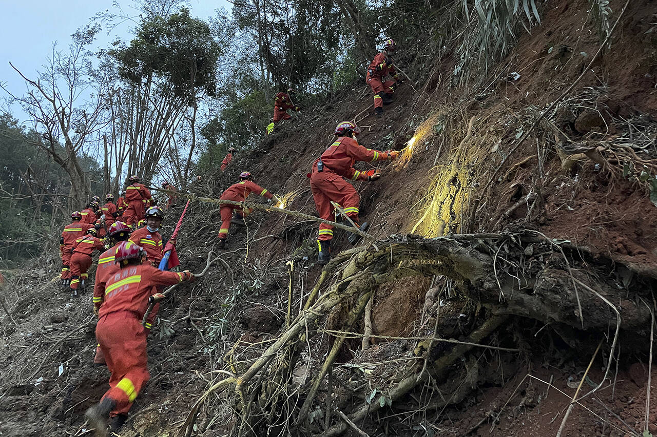 Rescuers conduct search operations at the site of a plane crash in Tengxian County in southern China’s Guangxi Zhuang Autonomous Region on Tuesday. (Zhou Hua/Xinhua via AP)