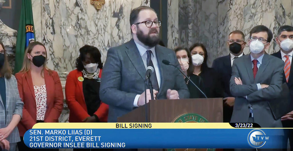 Sen. Marko Liias of Mukliteo spoke emotionally at the signing of three bills aimed at reducing gun violence, calling it an “honor and privilege to have been a part of this fight to make sure that future communities, future families, future parents, don’t have to experience the horror of July 2016 in Mukilteo.” (TVW/Screenshot)
