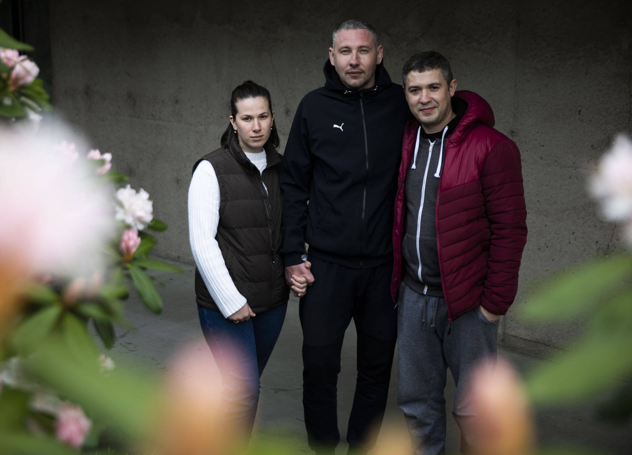 Nataliia Ktitorova (left), with her husband, Vitalii Ktitorov (center), and brother-in-law Yosip Lakatosh (right) at the Refugee & Immigrant Services Northwest office Thursday in Everett. (Olivia Vanni / The Herald)