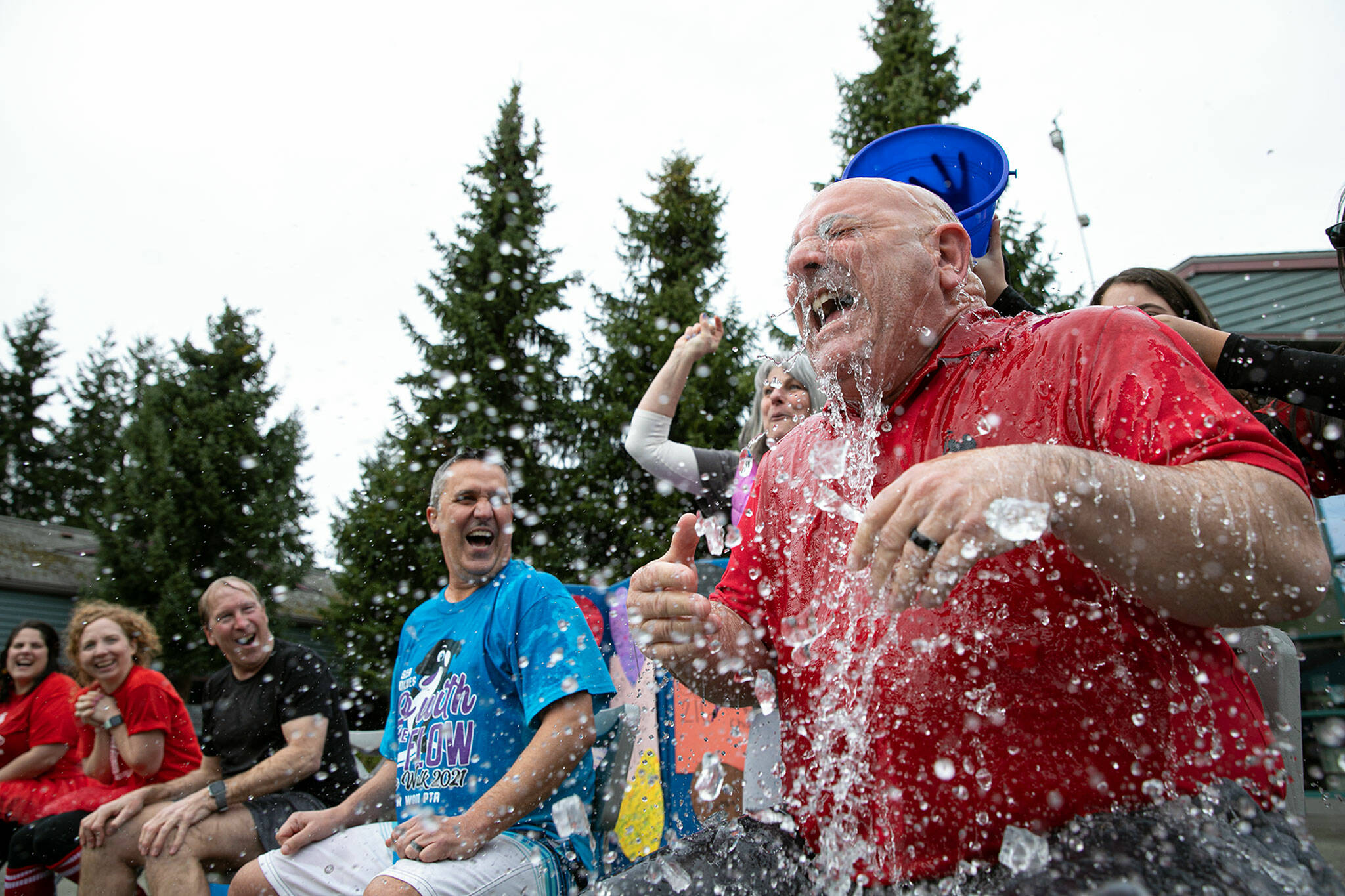 Everett Public Schools Superintendent Dr. Ian B. Saltzman gets drenched with a bucket of ice water on Thursday, March 24, at Cedar Wood Elementary School in Bothell. (Ryan Berry / The Herald)