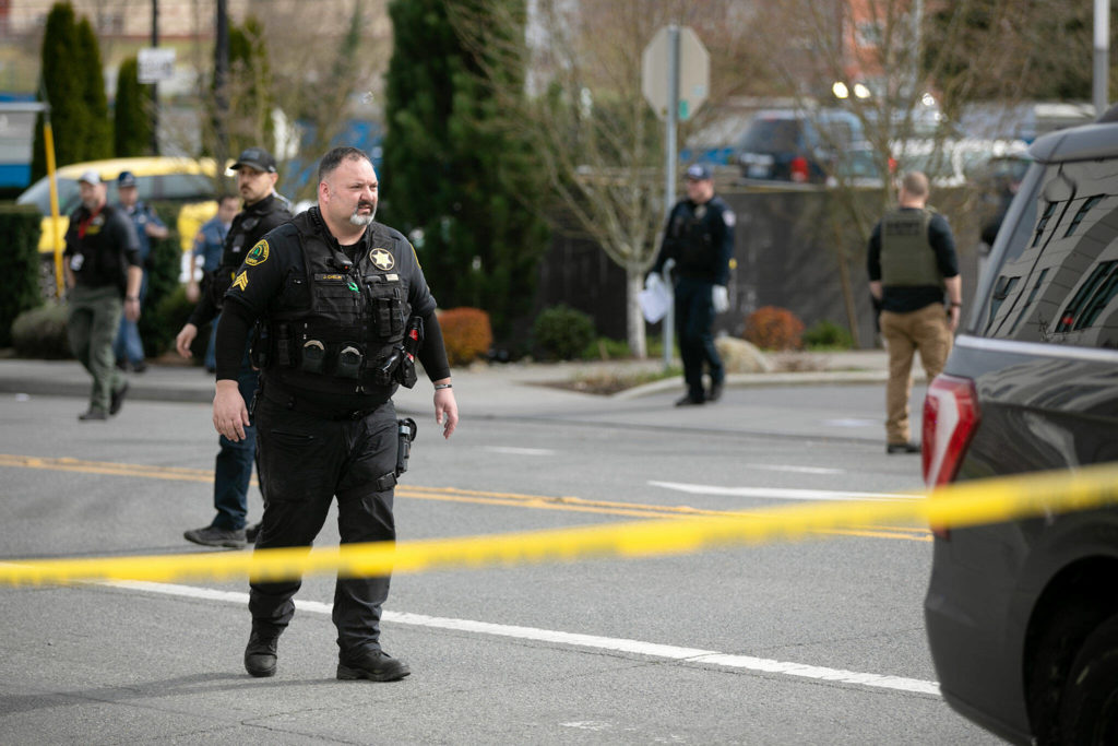 Law enforcement from multiple agencies work near the Starbucks of 1010 N Broadway where a person was killed Friday afternoon in Everett, Washington. (Ryan Berry / The Herald)

