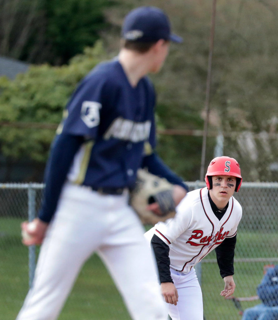 Arlington’s Ty Rusko, left, tracks Snohomish’s Solomon Heineman Friday afternoon at Snohomish High School. The Eagles won 4-2. (Kevin Clark / The Herald)
