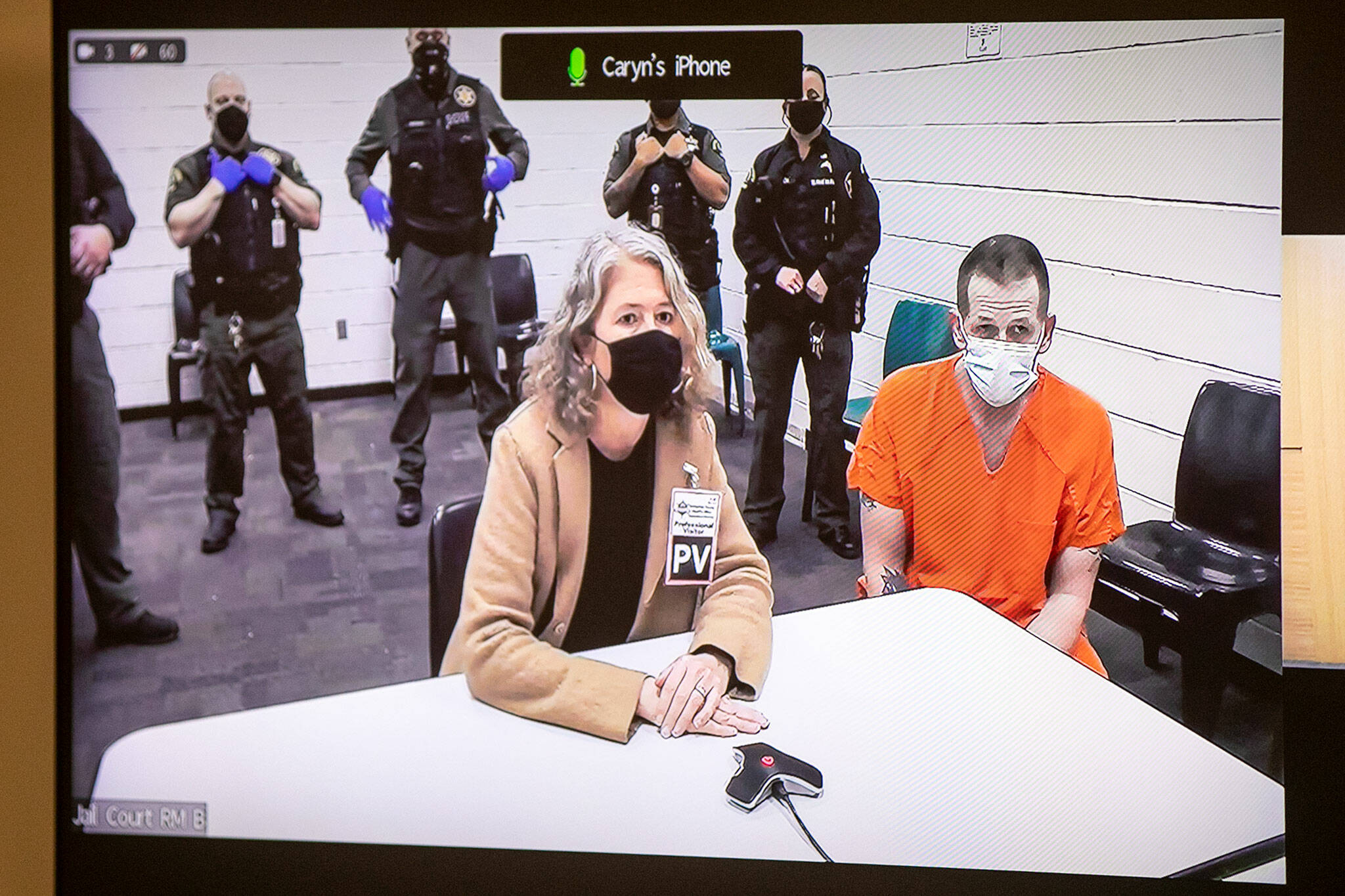Richard James Rotter (right), who is accused of killing Everett police officer Dan Rocha, appears in court via video Monday at the Snohomish County Courthouse in Everett. (Ryan Berry / The Herald)