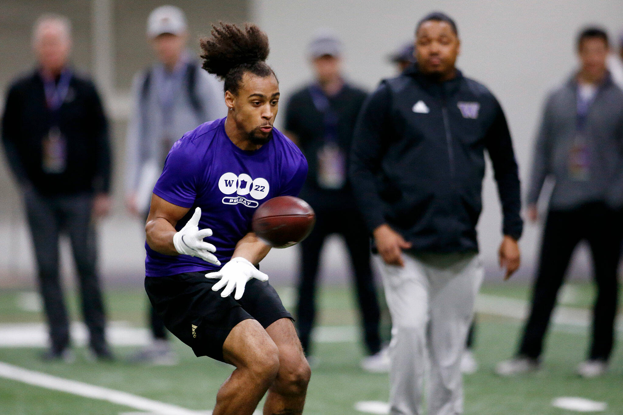 Kyler Gordon, an Archbishop Murphy High School graduate and University of Washington cornerback, catches a pass during positional drills at UW’s pro day Tuesday at the Dempsey Indoor Center in Seattle. (Ryan Berry / The Herald)