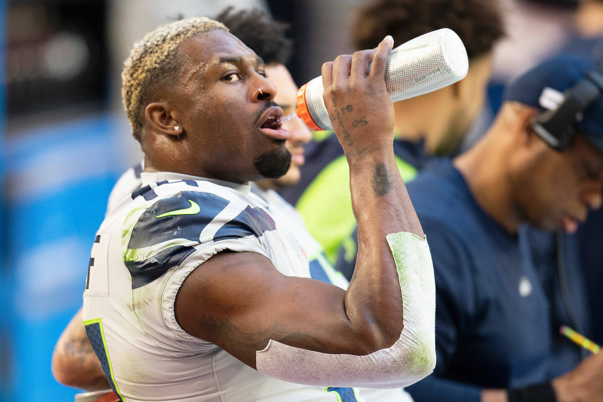 Seahawks wide receiver DK Metcalf takes a drink on the sideline during a game against the Cardinals on Jan. 9, 2022, in Phoenix. (AP Photo/John McCoy)