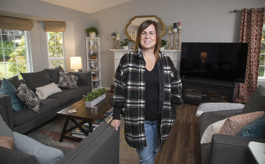 Shelly Henderson stands in her remodeled living room, which was designed by Kelly DuByne. (Andy Bronson)
