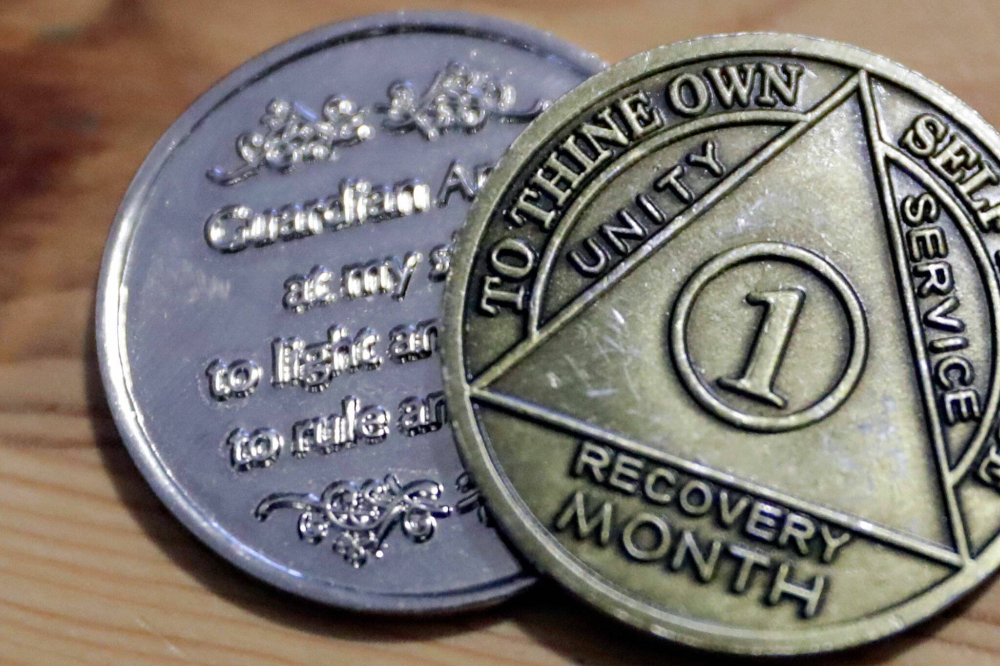 Randy Tharp’s recovery coins, which he received after battling fentanyl addiction. (Kevin Clark / The Herald)