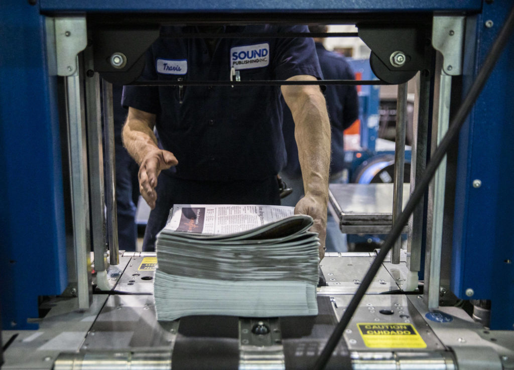 Copies of The Daily Herald are stacked and prepped for delivery at the Paine Field plant in Everett. (Olivia Vanni / The Herald)
