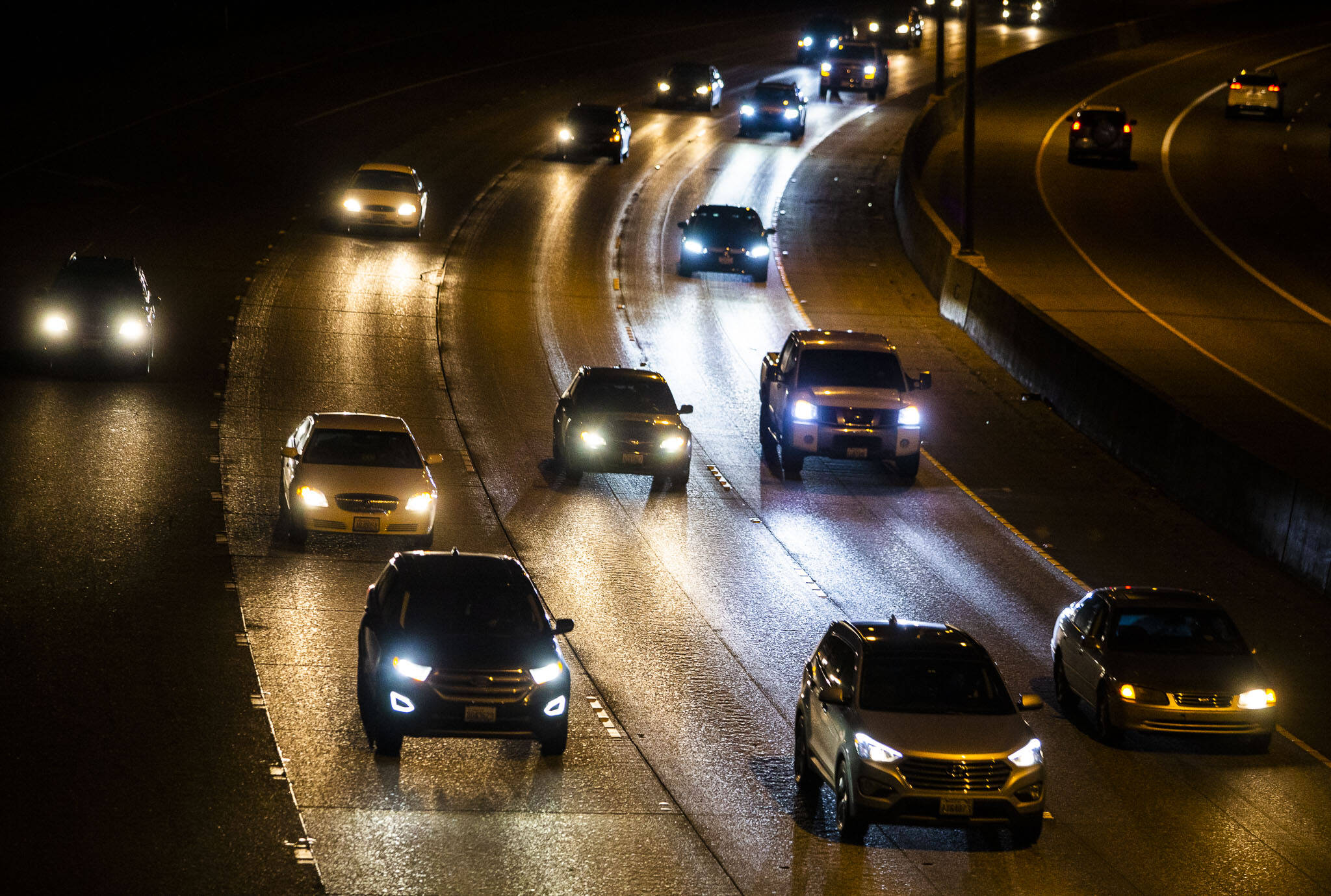 Drivers head north on I-5 through Everett on Thursday night. Blue-white hues from high-intensity discharge and light emitting diode headlights can seem brighter and cause more glare to human eyes. (Olivia Vanni / The Herald)