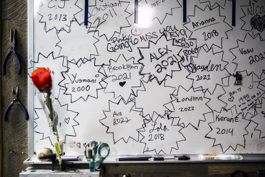 Names of former and current employees and the years they started working at the Everett Skate Deck cover a whiteboard in the skate room. (Olivia Vanni / The Herald)

