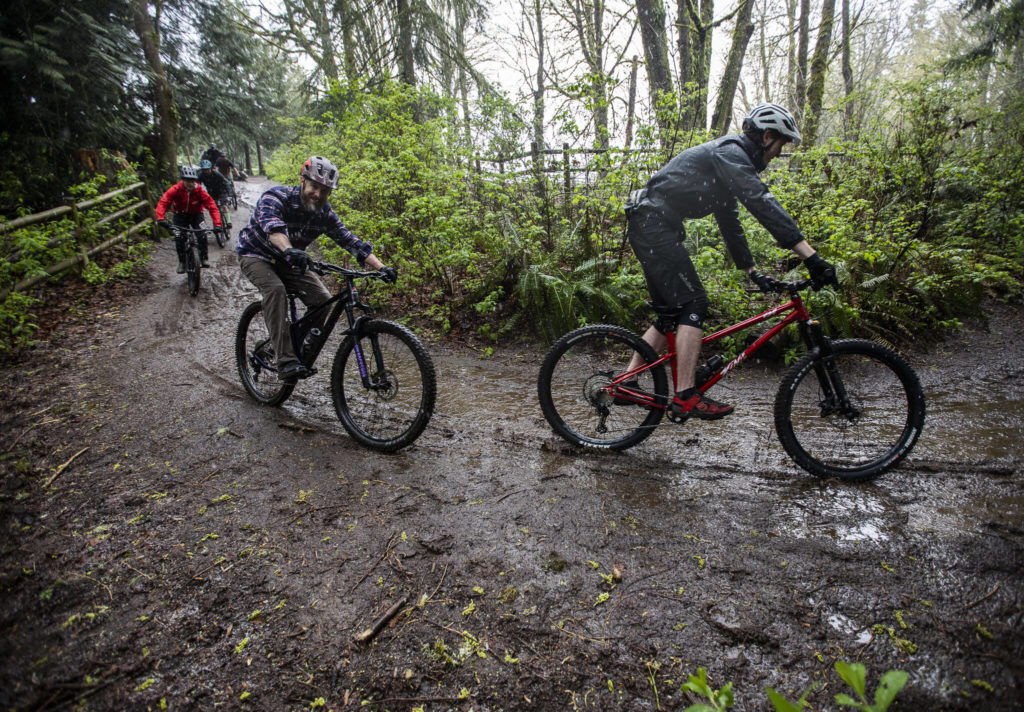 Bikers ride down a hill into Lord Hill Park near Snohomish during their gathering on April 10. (Olivia Vanni / The Herald)
