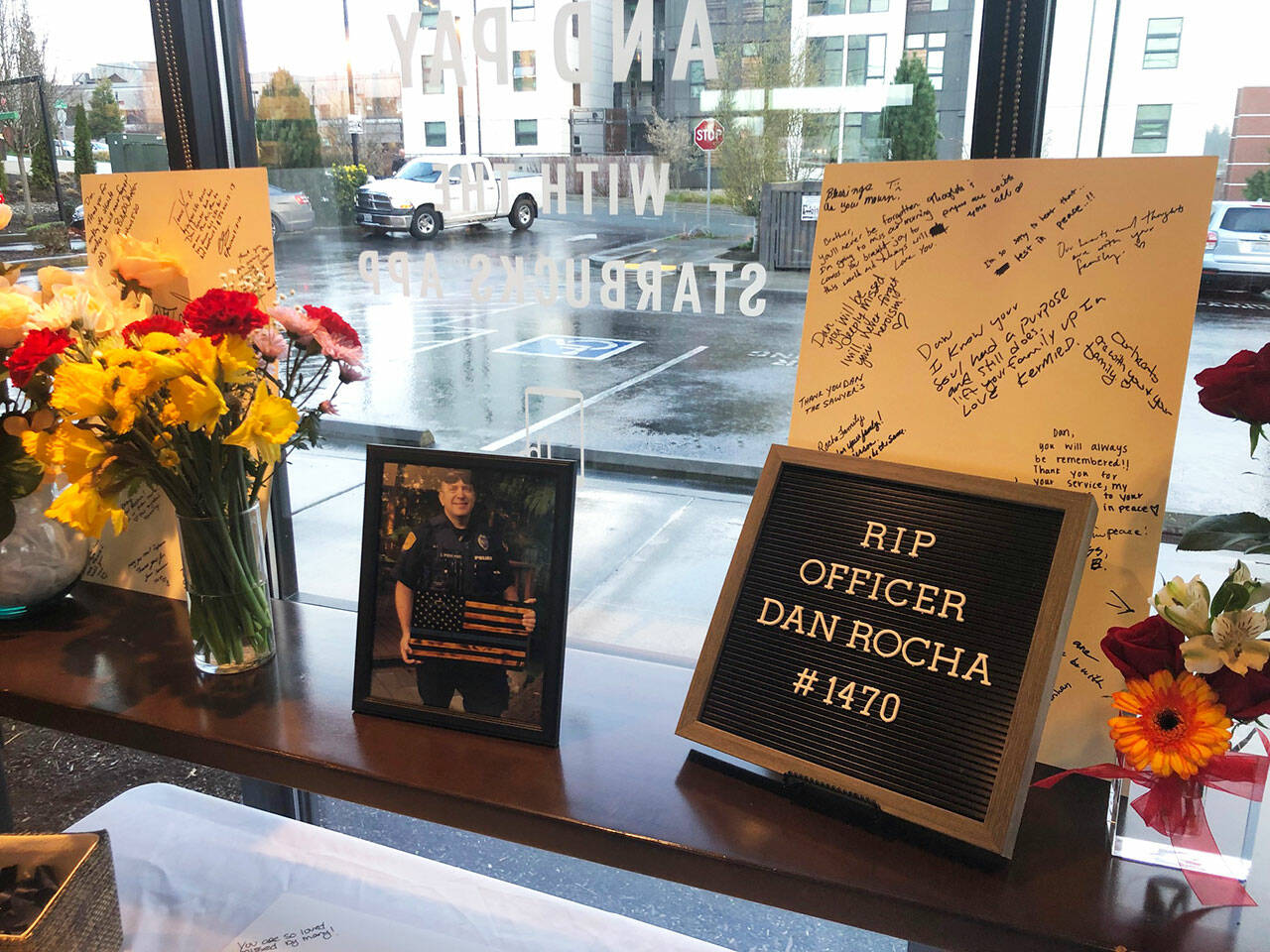 Along with a memorial to Everett Police Officer Dan Rocha at the downtown police station, customers at the north Everett Starbucks where he was a regular customer wrote notes to his family and left cards and flowers. (Jon Bauer / Herald staff)