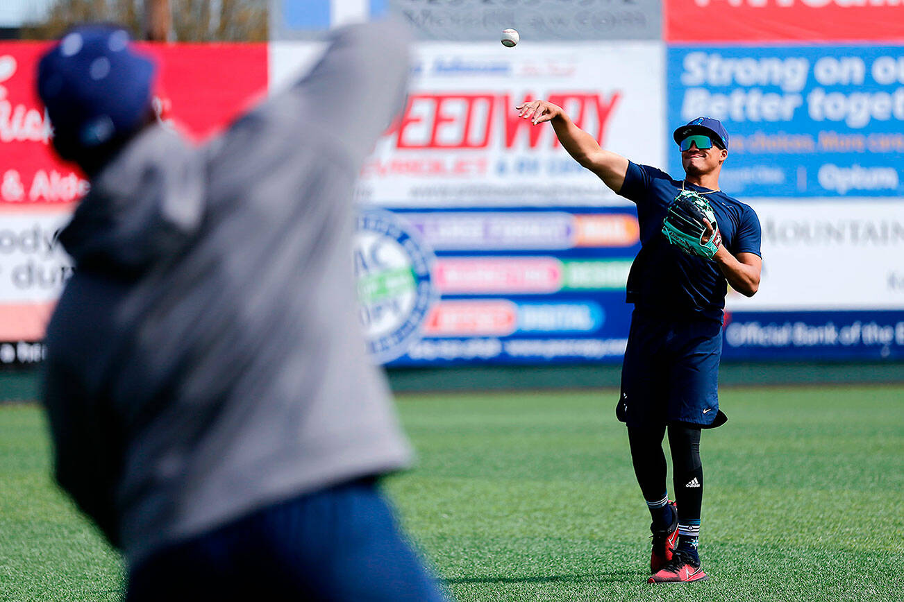 The Aquasox’s Noelvi Marte long-tosses with teammate Alberto Rodriguez during a team workout Wednesday, April 6, 2022, at Funko Field in Everett, Washington. (Ryan Berry / The Herald)