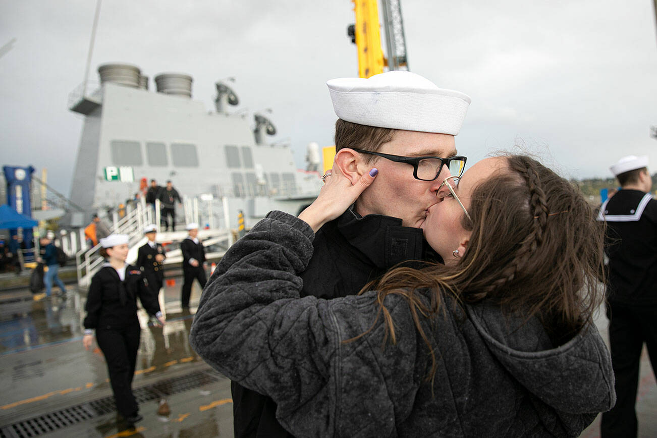 Sailors are greeted by loved ones as they disembark the USS McCampbell Friday, April 8, 2022, at Naval Station Everett in Everett, Washington. (Ryan Berry / The Herald)