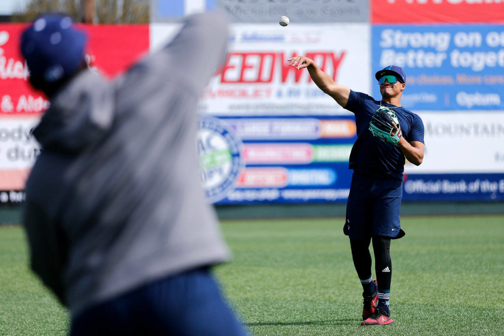 The AquaSox’s Noelvi Marte long-tosses with teammate Alberto Rodriguez. (Ryan Berry / The Herald)
