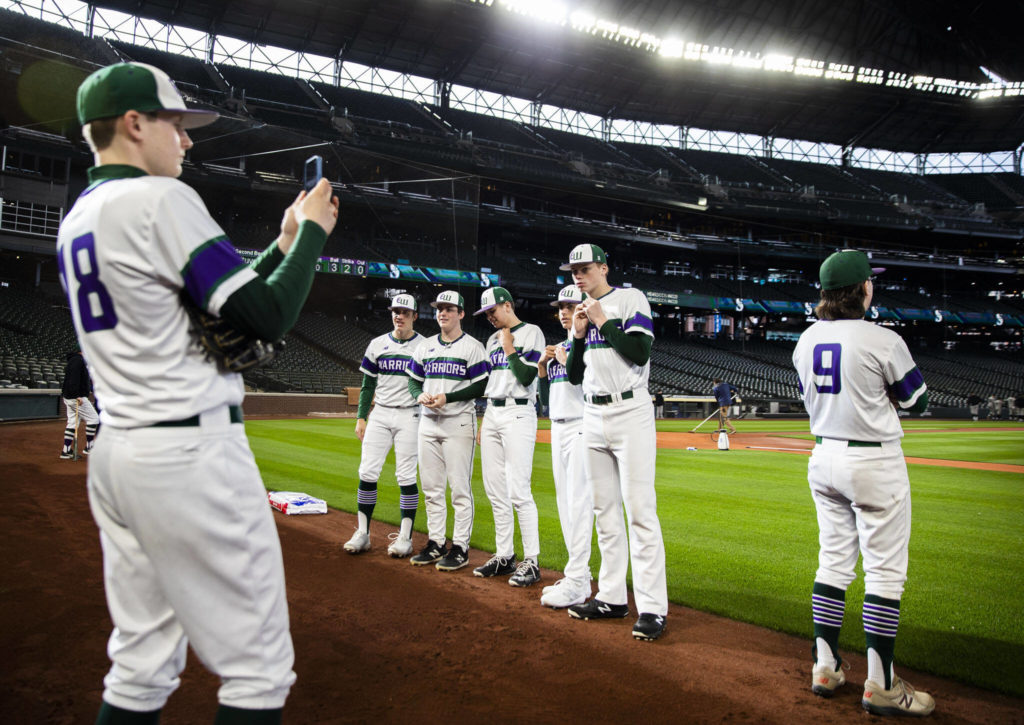 Edmonds-Woodway players pose for photos on the field before the game. (Olivia Vanni / The Herald)
