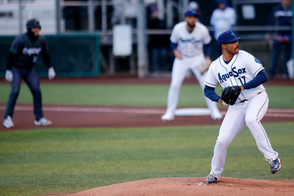 The AquaSox&rsquo;s Isaiah Campbell delivers a pitch with a runner on first during a game against Eugene Friday, April 8, 2022, at Funko Field in Everett, Washington. (Ryan Berry / The Herald)
