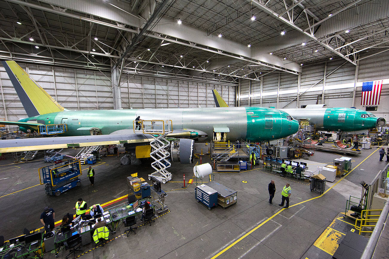 A worker uses a lift to get onto the wing of a KC-46 Pegasus tanker plane, one of four, at the Boeing Everett Modification Center on Friday, May 12, 2017 in Everett, Wa. (Andy Bronson / The Herald)