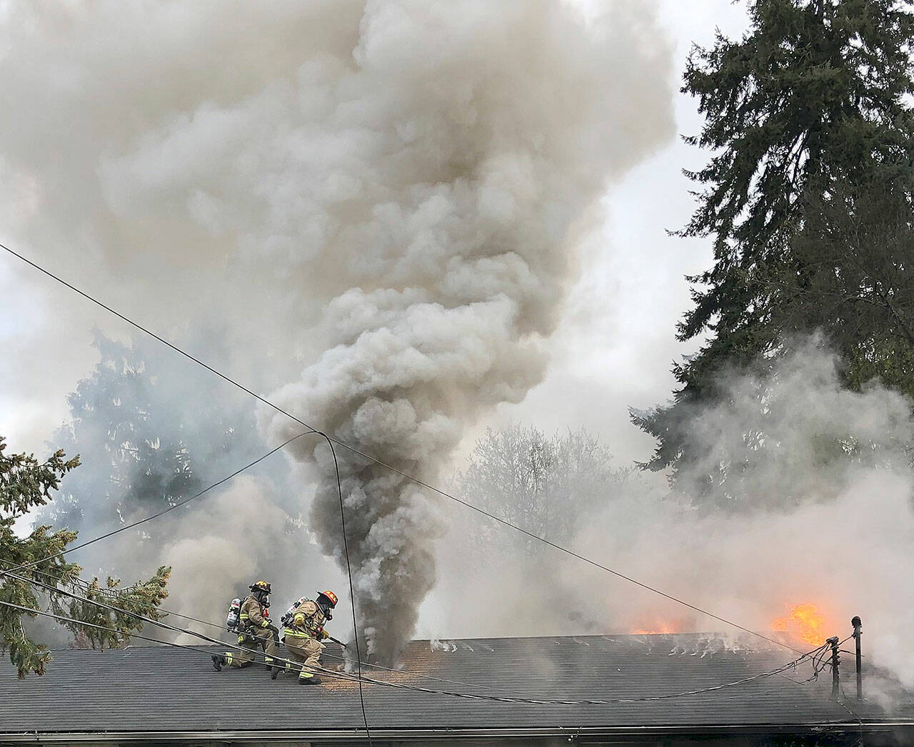 Firefighters douse flames and smoke coming from a house in the 5300 block of 88th Street NE Tuesday morning in Marysville. (Marysville Fire Department)