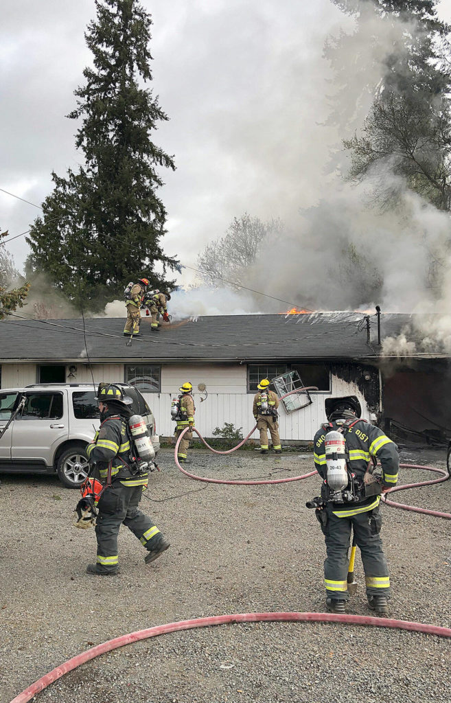 Firefighters contain flames at a house fire in the 5300 block of 88th Street NE Tuesday morning in Marysville. (Marysville Fire Department)
