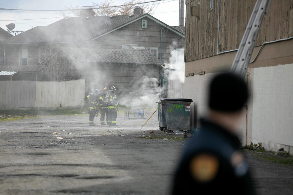 Firefighters work at the far end of the strip mall at 9629 Evergreen Way while responding to a fire Thursday, April 13, 2022, in Everett, Washington. (Ryan Berry / The Herald)
