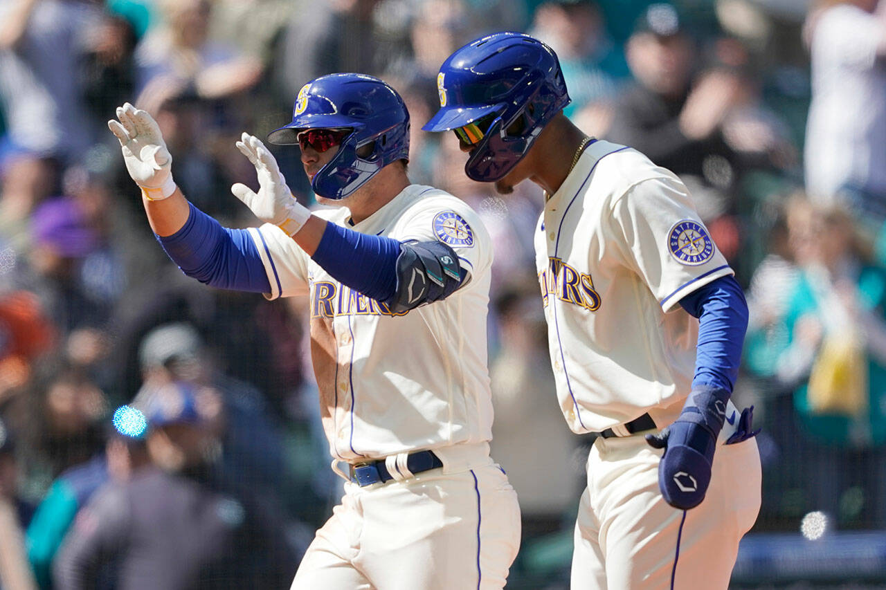 Seattle Mariners’ Ty France (left) reacts with Julio Rodriguez after France hit a three-run home run to score Rodriguez and Adam Frazier during the fourth inning of a game against the Houston Astros on Sunday in Seattle. (AP Photo/Ted S. Warren)