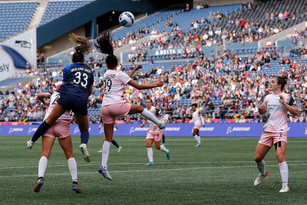 OL Reign’s Olivia Van der Jagt sends a header up and over the hands of the goalie for the game winning goal in stoppage time during a NWSL Challenge Cup matchup against Angel City FC Sunday, April 17, 2022, at Lumen Field in Seattle, Washington. (Ryan Berry / The Herald)
