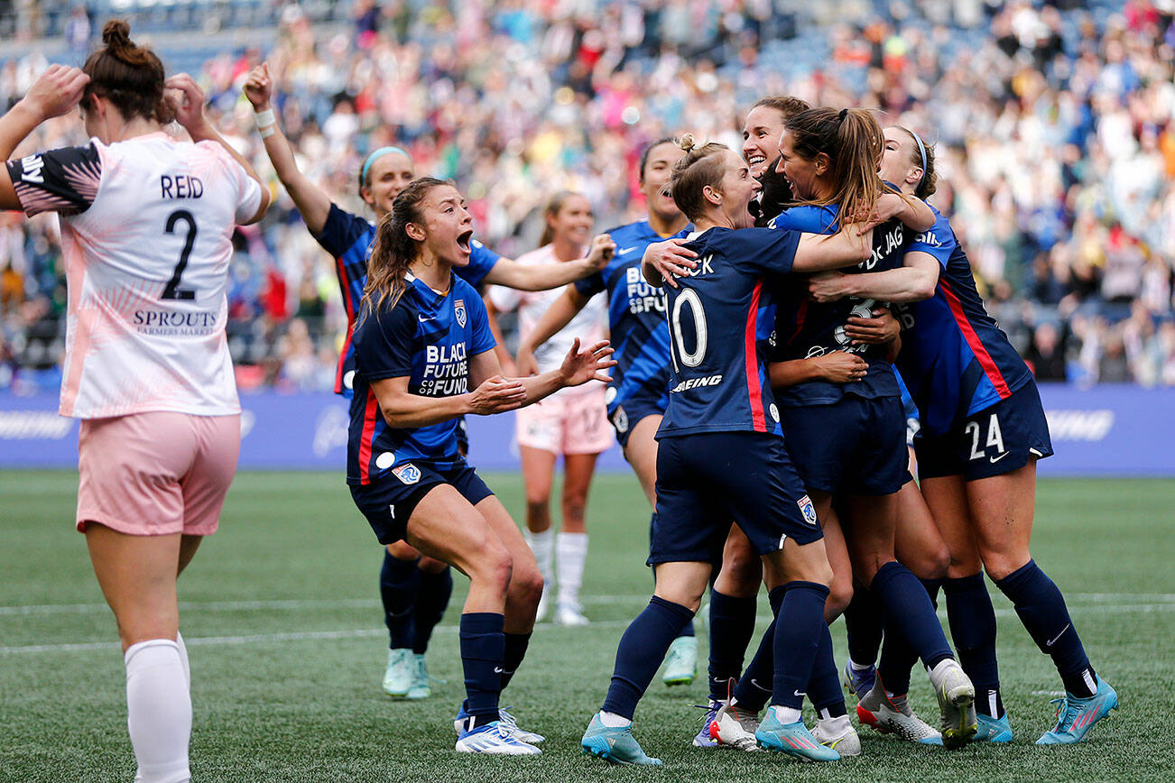 The OL Reign celebrate Olivia Van der Jagt’s game winning goal in stoppage time of a NWSL Challenge Cup matchup against Angel City FC Sunday, April 17, 2022, at Lumen Field in Seattle, Washington. (Ryan Berry / The Herald)