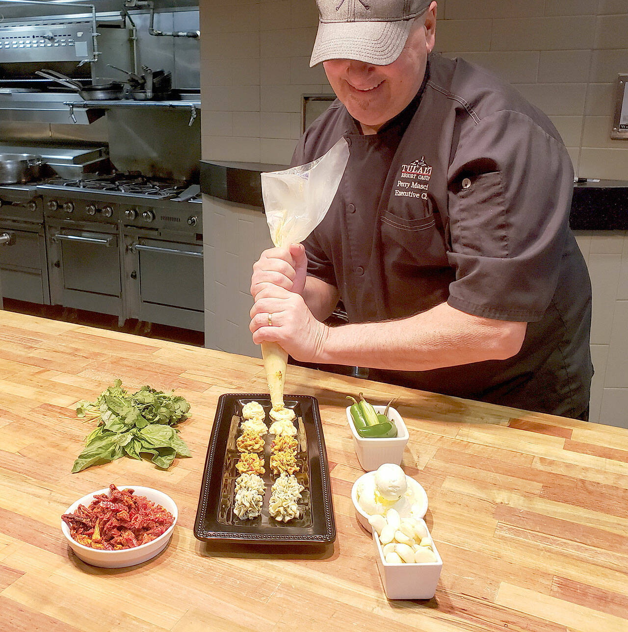 Tulalip Resort Casino executive chef Perry Mascitti pipes out some compound butter coins. (Tulalip Resort Casino)