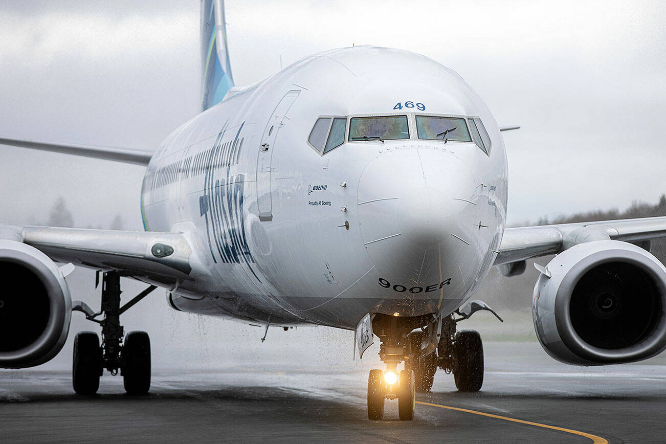 Water drips from an Alaska Airlines Boeing 737 after it received a water salute while becoming the first scheduled 737 arrival Thursday, Feb. 17, 2022, at Paine Field Airport in Everett, Washington. (Ryan Berry / The Herald)
