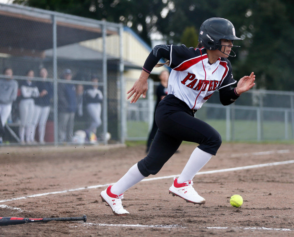 Snohomish’s Bridget Johnson lays down a bunt and beats out the throw against Arlington Tuesday, April 19, 2022, at Snohomish High School in Snohomish, Washington. (Ryan Berry / The Herald)
