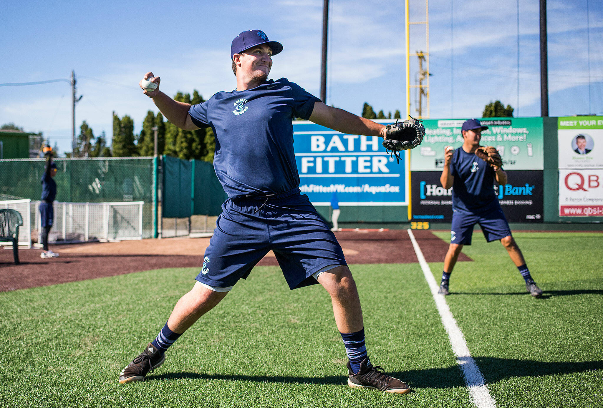 The AquaSox’s Trent Tingelstad (front), a Marysville Pilchuck graduate, warms up before a practice in 2019 at Funko Field in Everett. (Andy Bronson / The Herald)