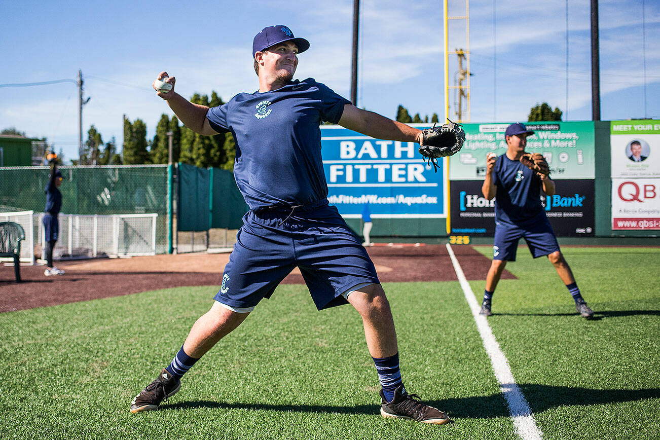 Everett AquaSox players Trent Tingelstad, front, and Austin Shenton warm up at Funko Field on the first day of practice on Tuesday, June 11, 2019 in Everett, Wash. Tingelstad resides in Marysville while Shenton is from Bellingham. (Andy Bronson / The Herald)