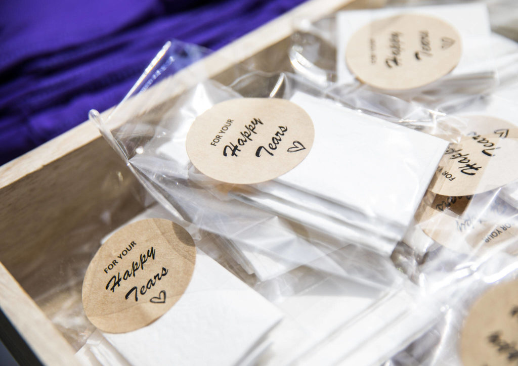 Small packets of tissues for “happy tears” sit on a table for friends and family to use on Saturday, April 23, 2022 in Bothell, Washington. (Olivia Vanni / The Herald)
