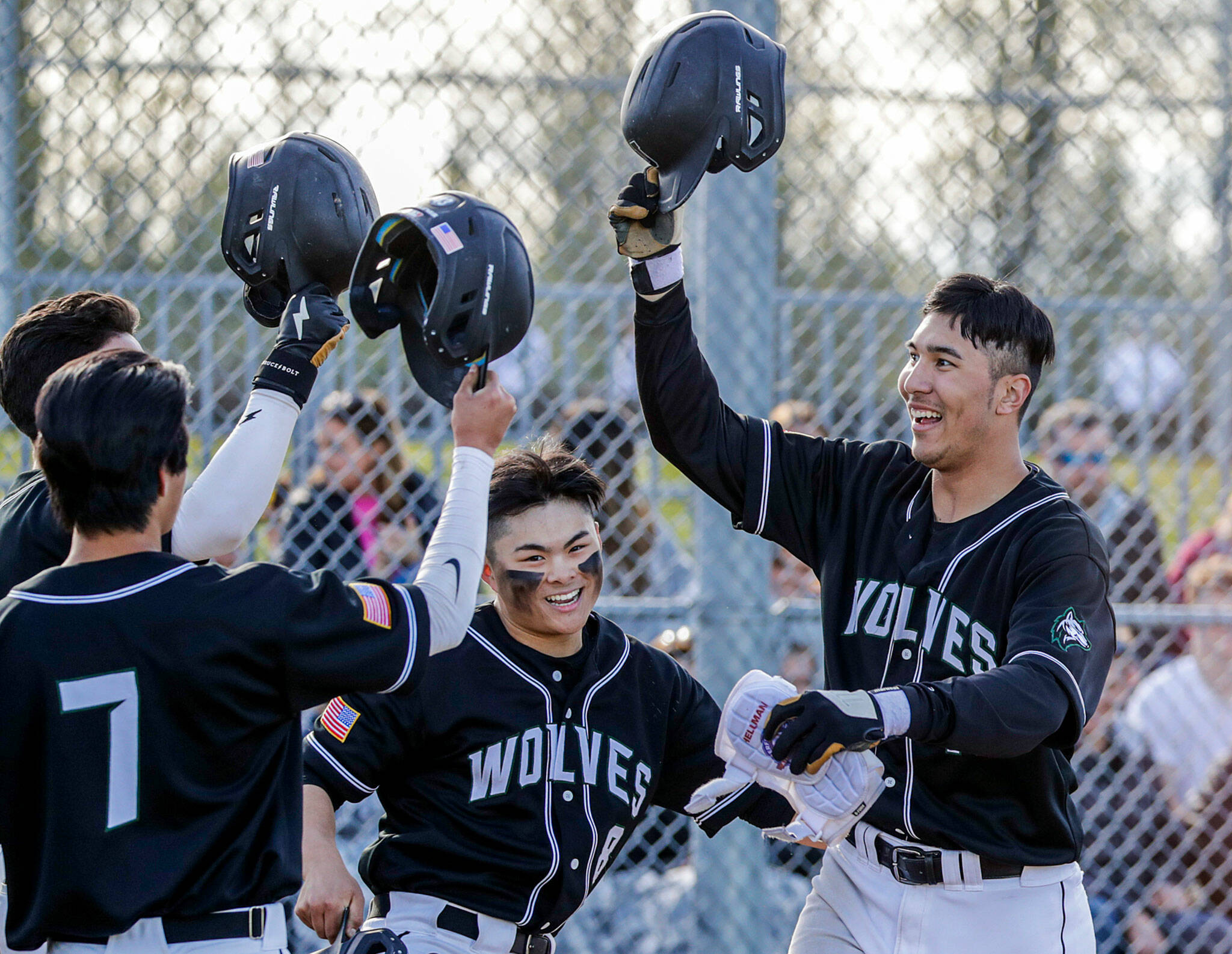 Jackson star Dominic Hellman, right, celebrates his three-run homer during the Timberwolves’ 12-4 win over Glacier Peak on Friday afternoon. (Kevin Clark / The Herald)