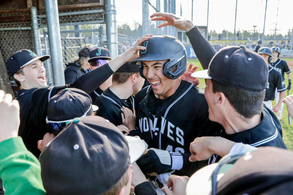 Hellman is congratuled by teammates after blasting his sixth homer of the season. (Kevin Clark / The Herald)
